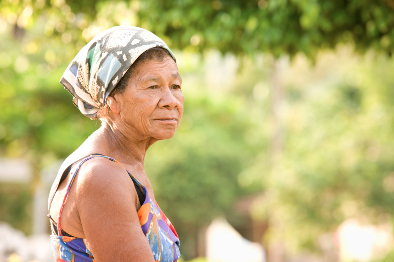 A woman wearing a bandana looks off camera.